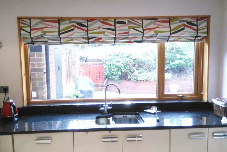 Patterned curtains in small kitchen