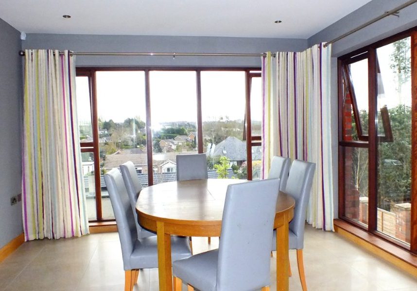 House extension with floor to ceiling windows with stripped curtains