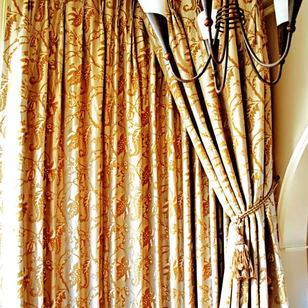 Fancy gold curtains with fabric tie backs
